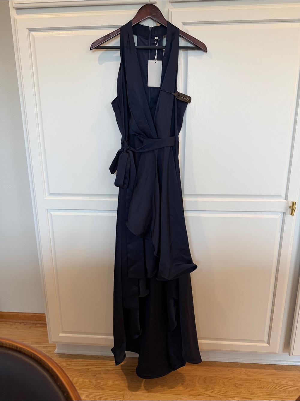 Navy Halter Wrap High Low Dress with Sash Waist and Elegant Ruffled Skirt.